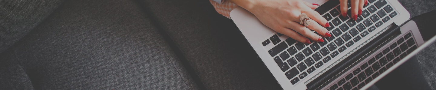 human hand typing on laptop