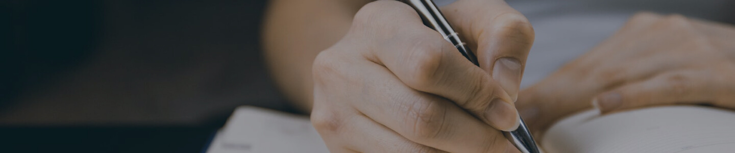 human hand writing on book