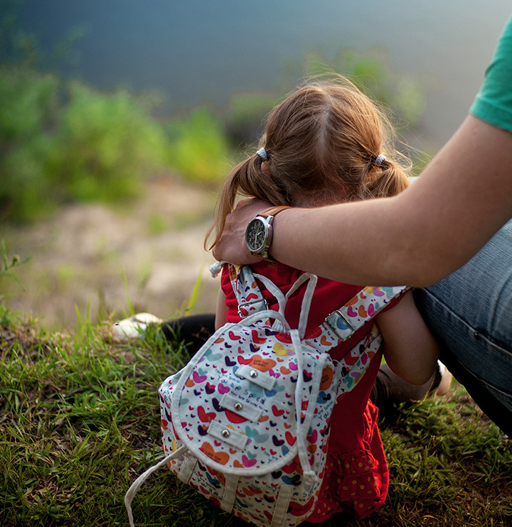 father's hand on daughter's neck