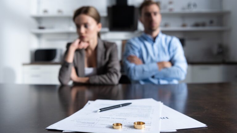 couple sitting at table with divorce documents
