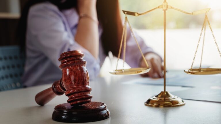 Female attorney is discussing with the client divorce the case in court