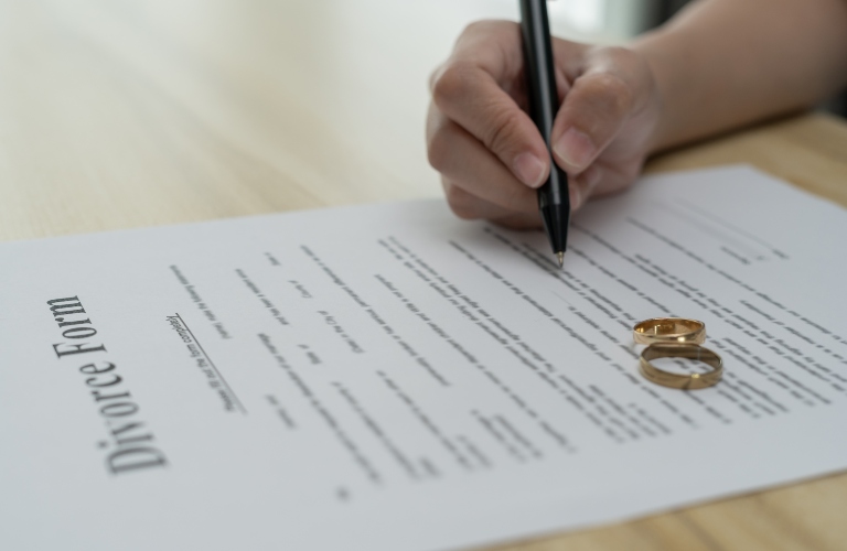 woman fills out divorce form