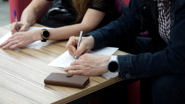 Adult man and woman fill out the forms