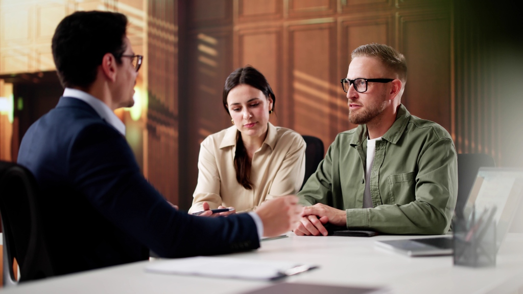 Family lawyer consulting on divorce case with a couple