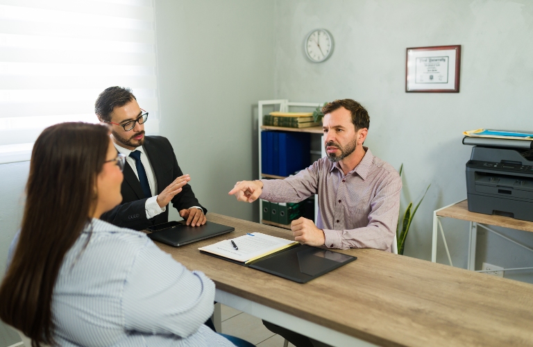 Man and woman discussing their legal separation with an attorney