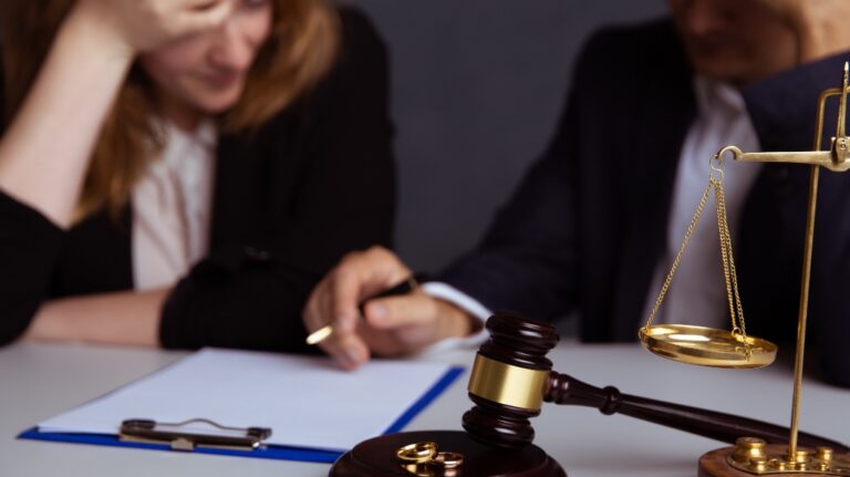 Couple going through divorce signing papers
