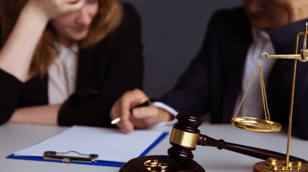 Couple going through divorce signing papers